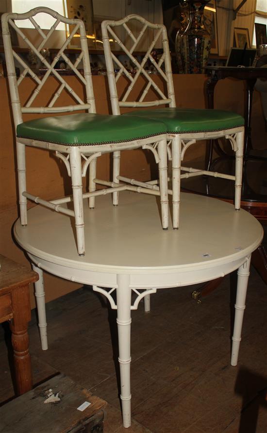 White painted circular topped table and 6 faux bamboo chairs (5)